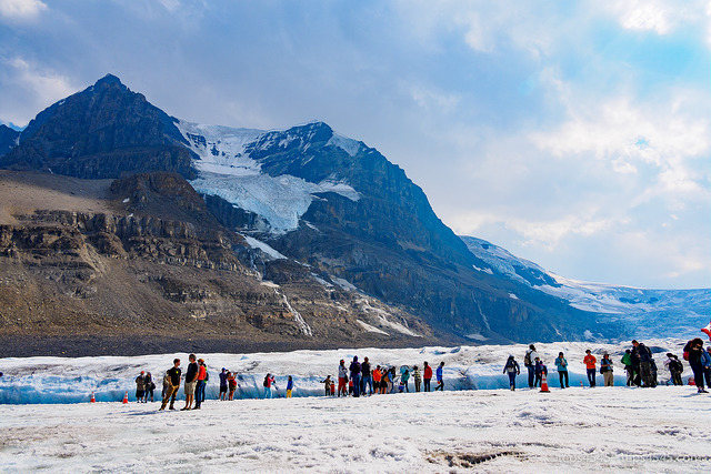 Tourists walk on glacier